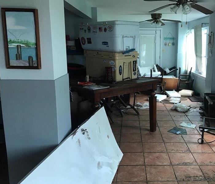 Kitchen damaged from Hurricane damage with water damage to the floors and lower walls