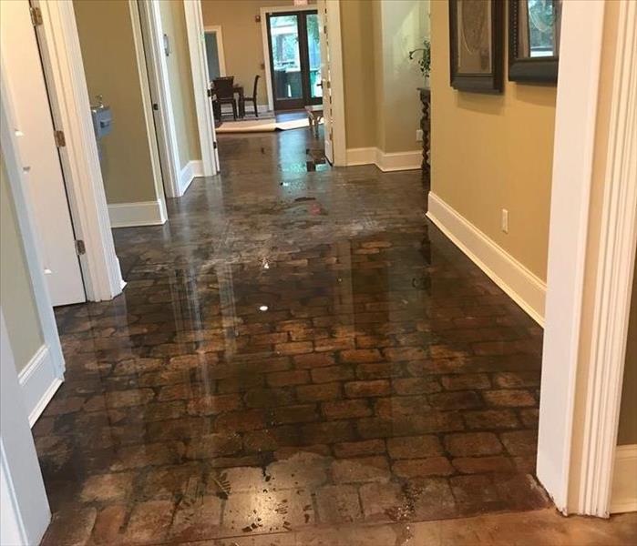 A photo of a flooded tile floor in the lobby of a community clubhouse.
