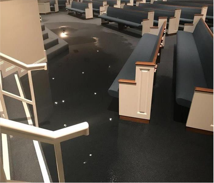 A Sanctuary with stand still water on the carpet at the front of the room