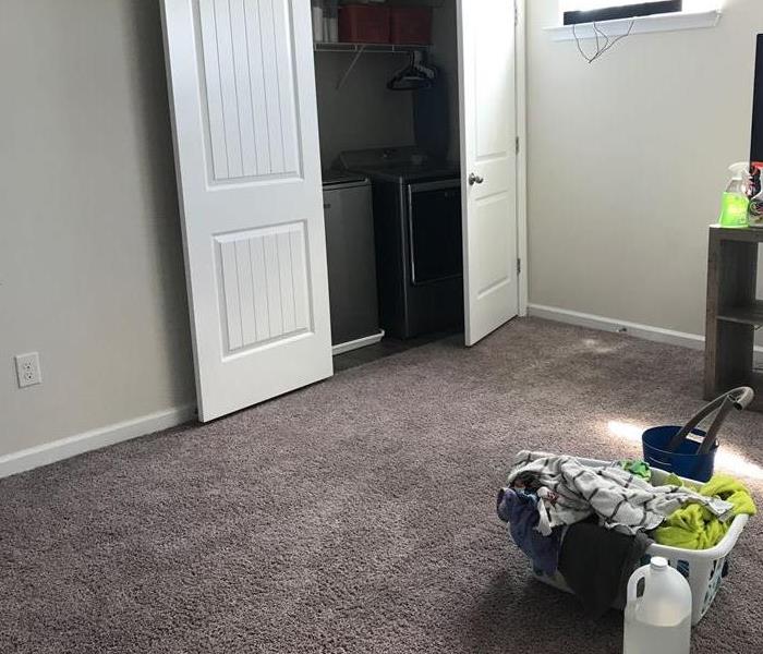 Laundry landing with saturated carpet