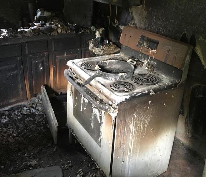 burnt remains of a kitchen stove and surrounding counters