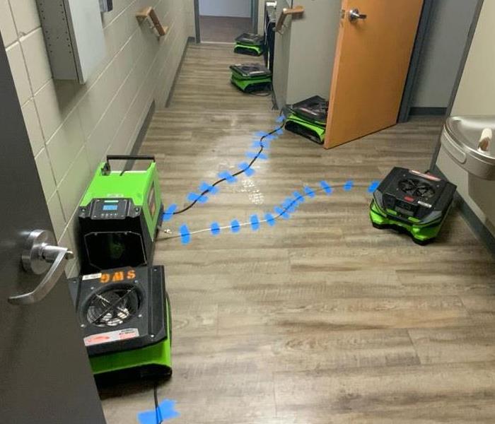 SERVPRO Green drying equipment placed in hallway 