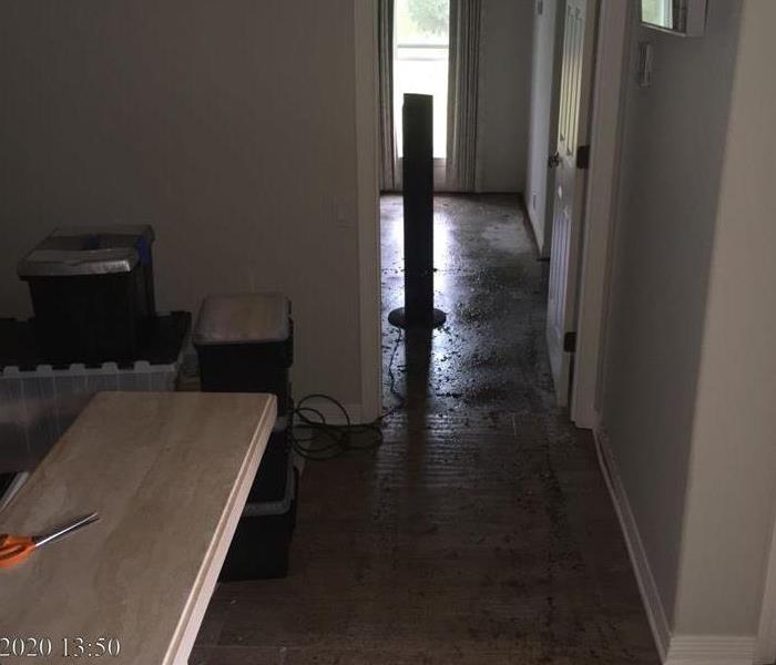 Floor in hallway and bedroom entrance showing water on the ground from flooding due to storm surge