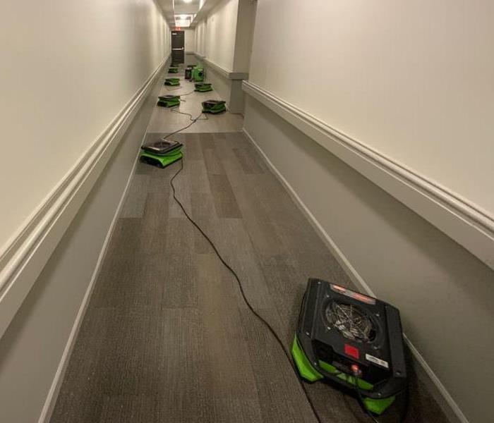 SERVPRO Green drying equipment placed in hallway 